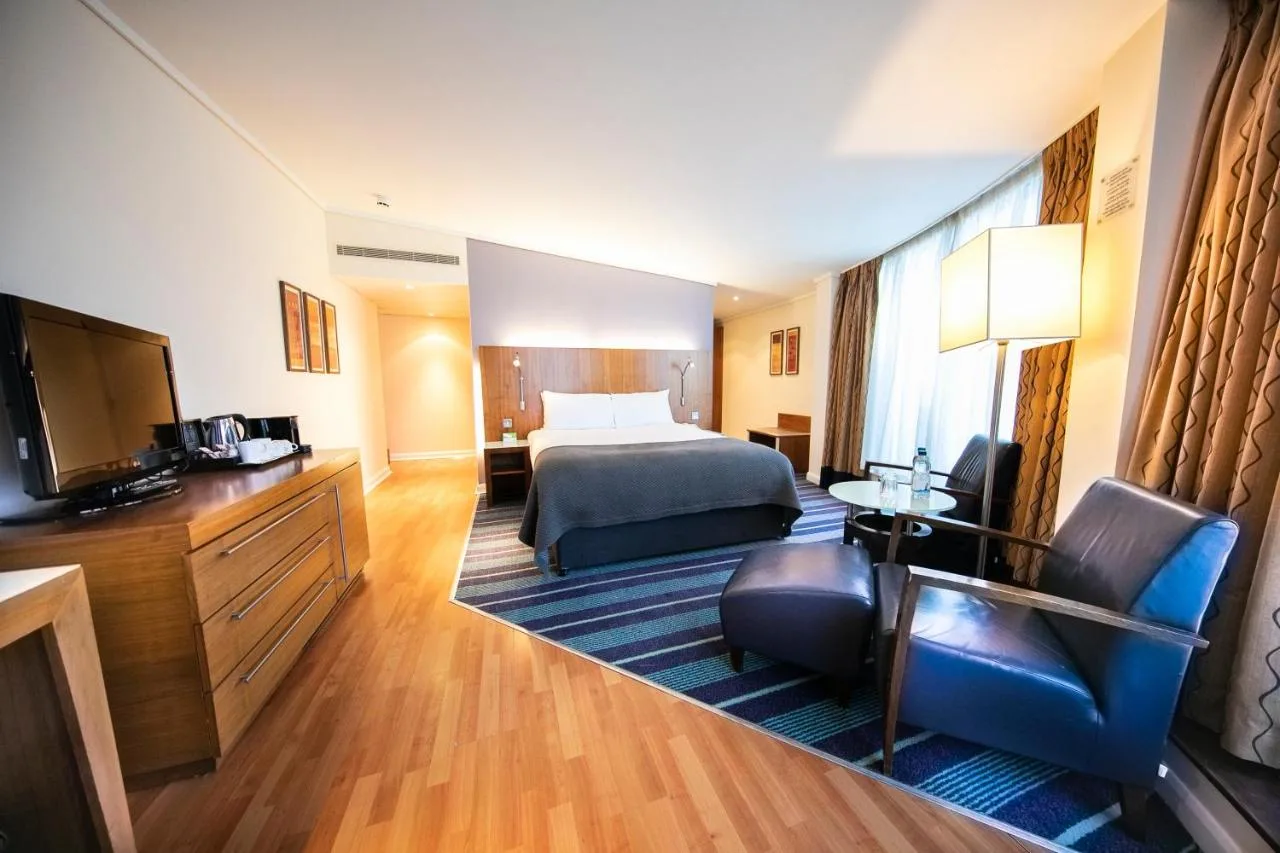 a hotel room with a bed and a television at Holiday Inn London Camden Lock by IHG in London