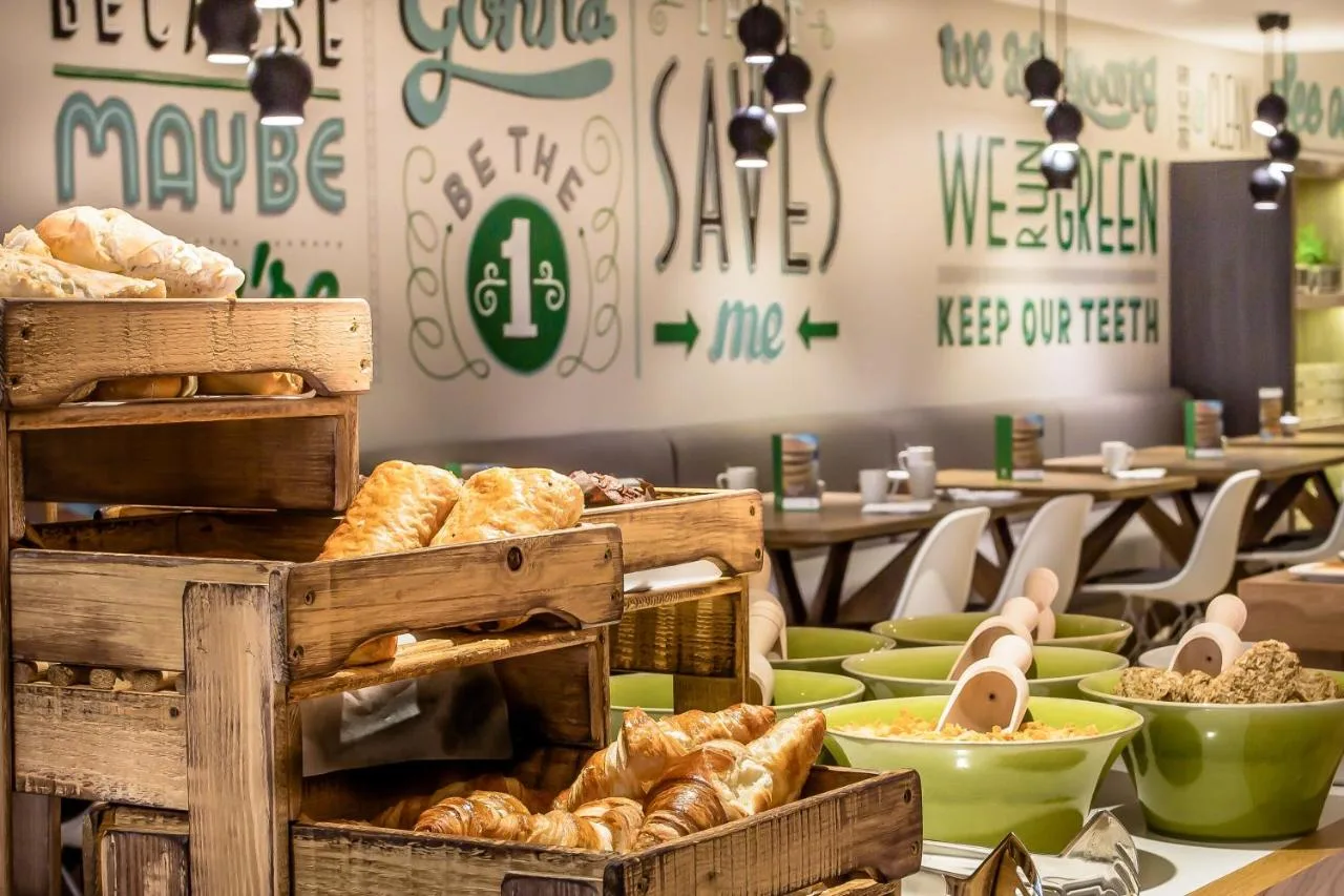 a bakery with bread and pastries on a table at Holiday Inn London Camden Lock by IHG in London