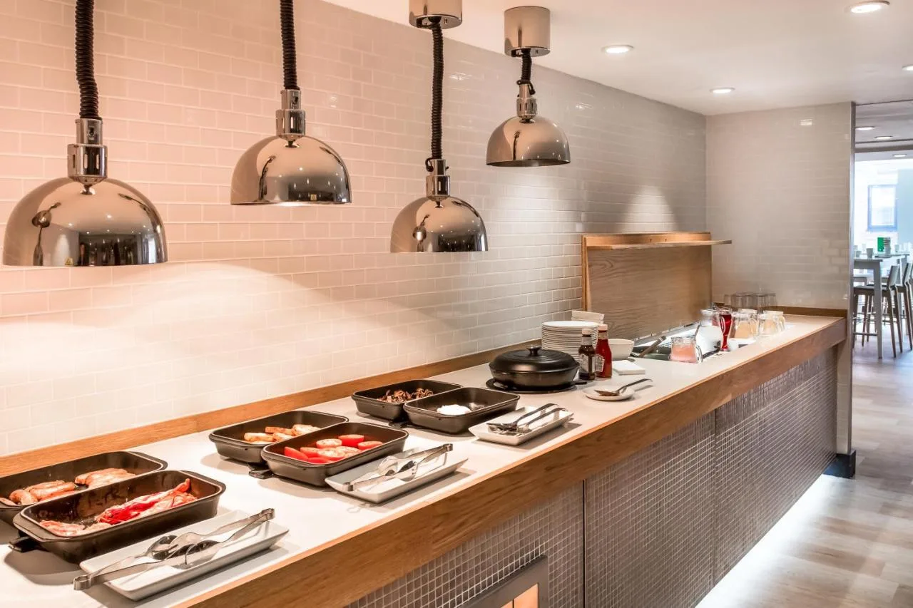 a kitchen with a stove top with pots and pans at Holiday Inn London Camden Lock by IHG in London